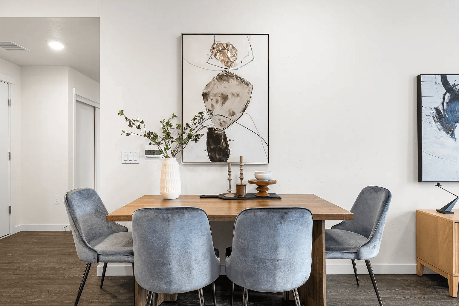 A dining room with a table and chairs.
